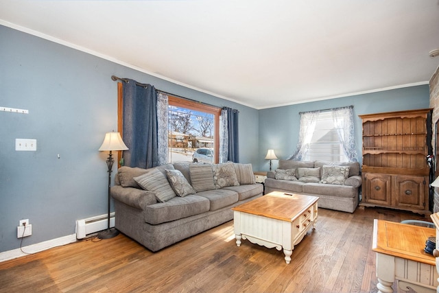 living room featuring baseboard heating, crown molding, and hardwood / wood-style flooring