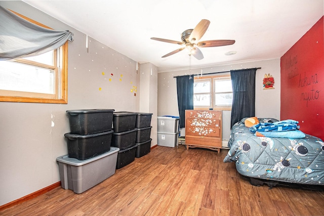 bedroom with hardwood / wood-style flooring and ceiling fan