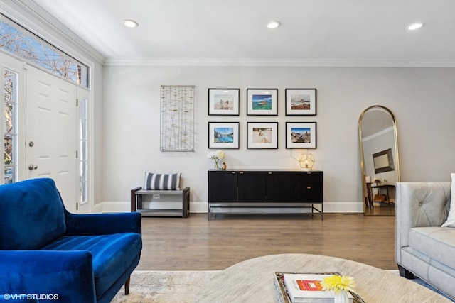 living room with ornamental molding, recessed lighting, wood finished floors, and baseboards