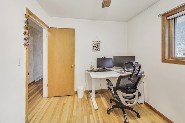 office area with ceiling fan and light hardwood / wood-style floors