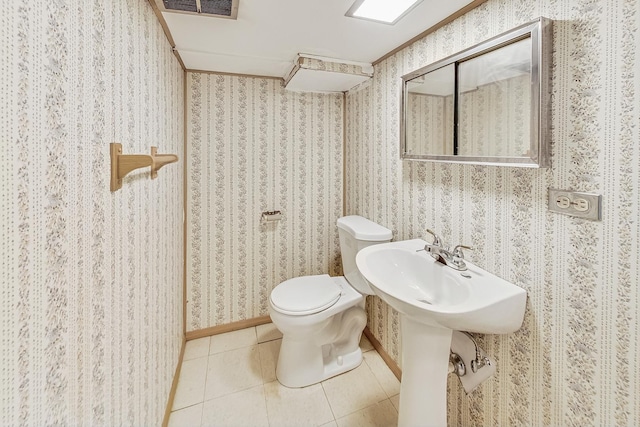 bathroom with toilet and tile patterned flooring