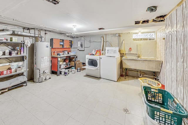 basement with washer and clothes dryer, water heater, sink, and electric panel