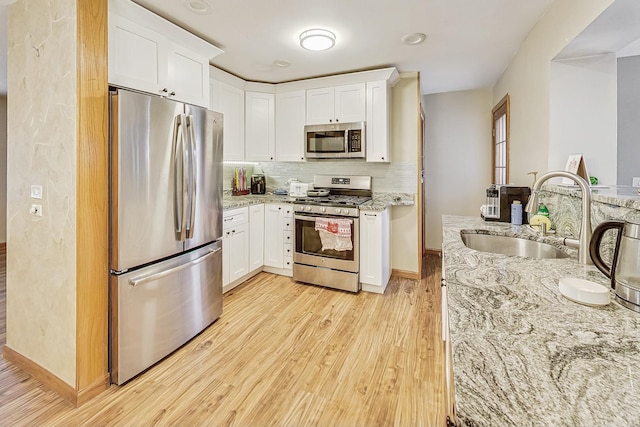 kitchen with sink, white cabinetry, and stainless steel appliances