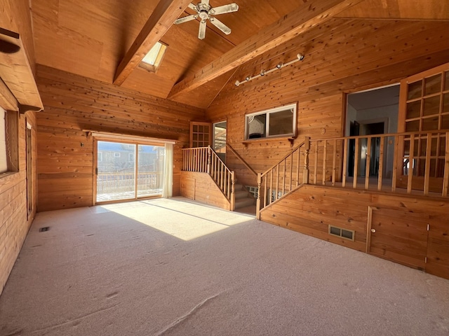 unfurnished living room with high vaulted ceiling, wooden ceiling, carpet floors, and beamed ceiling