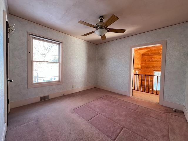 carpeted empty room featuring ceiling fan