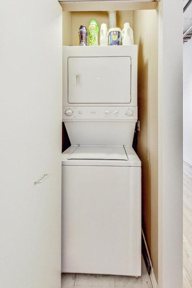 laundry room with stacked washer / dryer