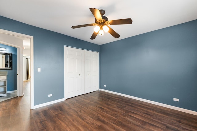 unfurnished bedroom with dark hardwood / wood-style floors, ceiling fan, and a closet