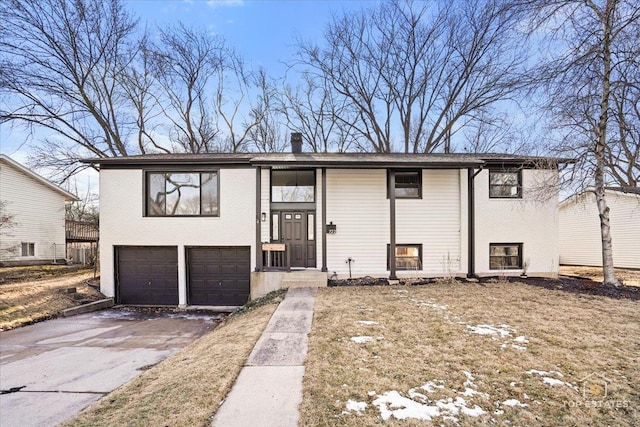 raised ranch featuring a garage and central AC unit