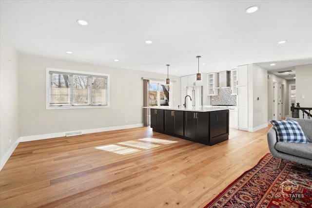 living room featuring sink and light hardwood / wood-style flooring