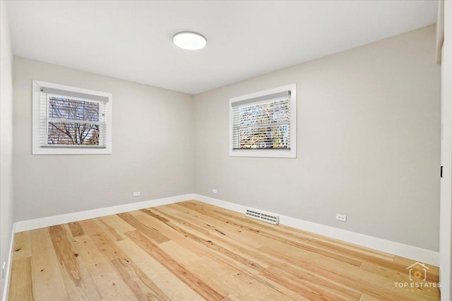 spare room with hardwood / wood-style floors