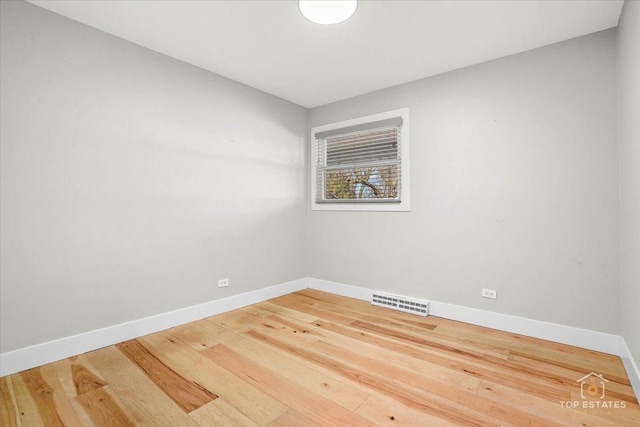 spare room with hardwood / wood-style flooring