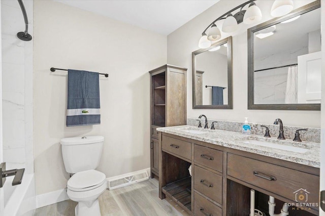 bathroom featuring hardwood / wood-style flooring, vanity, and toilet