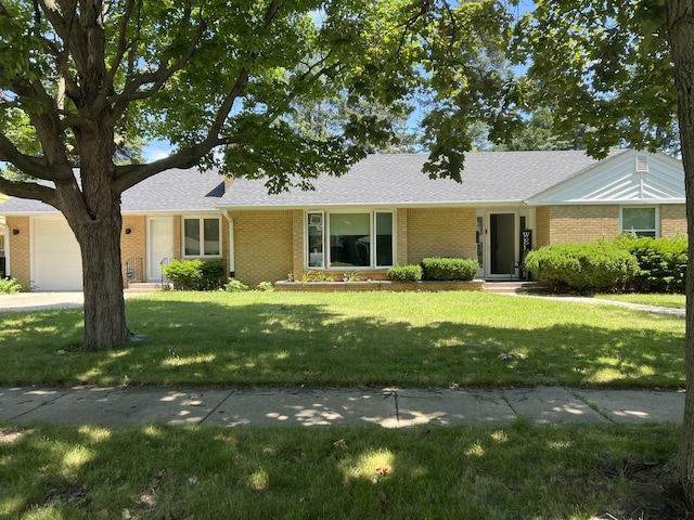 single story home featuring a front yard and a garage