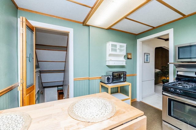 kitchen with stainless steel appliances and crown molding