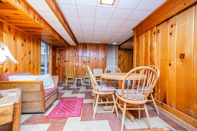 dining room featuring wood walls