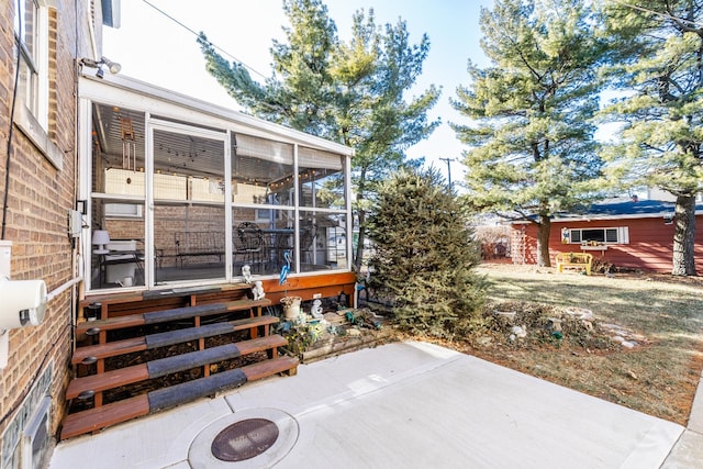 view of patio / terrace featuring a sunroom