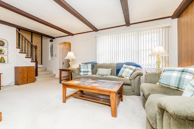 carpeted living room featuring beam ceiling