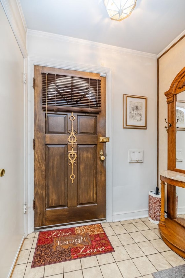 foyer entrance with crown molding and light tile patterned flooring