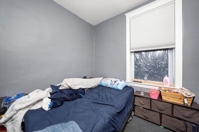 carpeted bedroom with vaulted ceiling