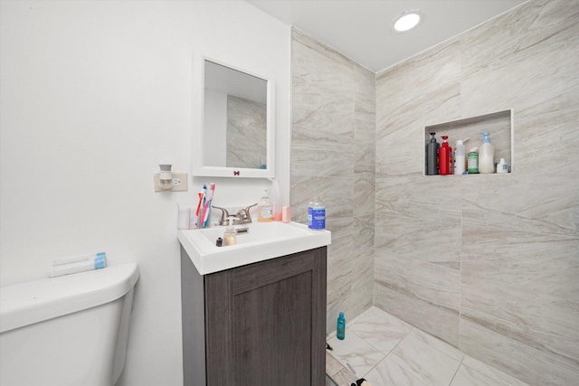 bathroom featuring toilet and vanity