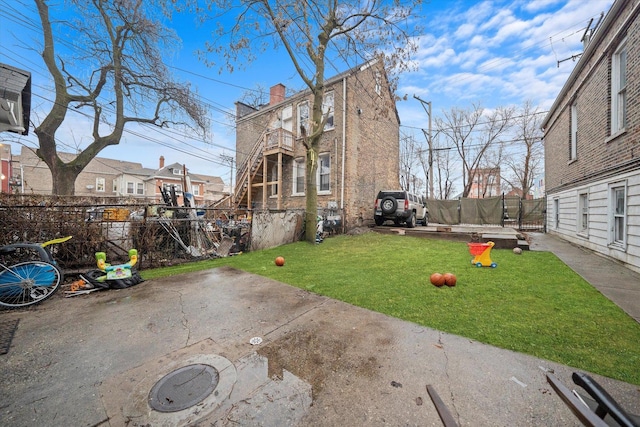 view of yard with a trampoline and a patio area