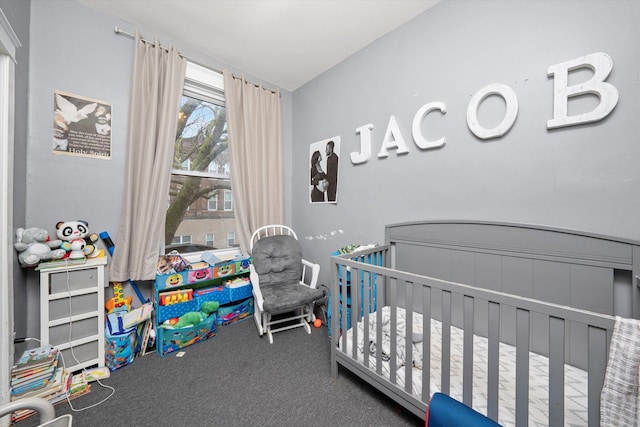 bedroom with carpet floors and a crib