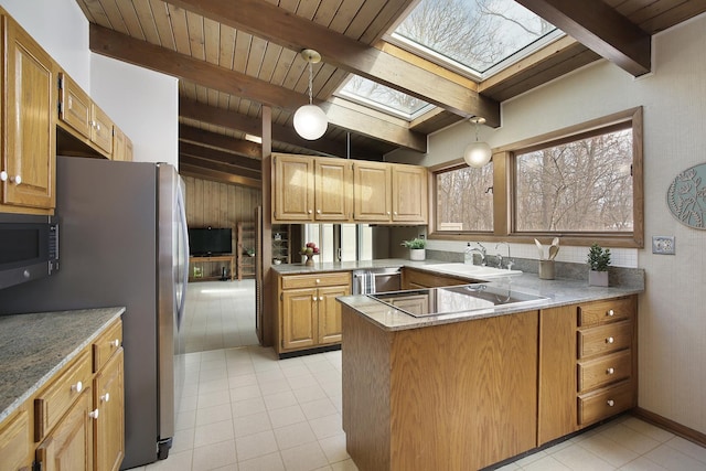 kitchen featuring vaulted ceiling with skylight, black appliances, kitchen peninsula, sink, and wooden ceiling