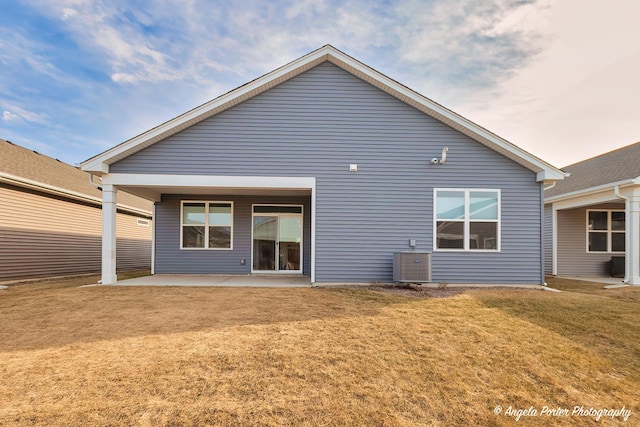 back of house with a yard, a patio area, and central AC