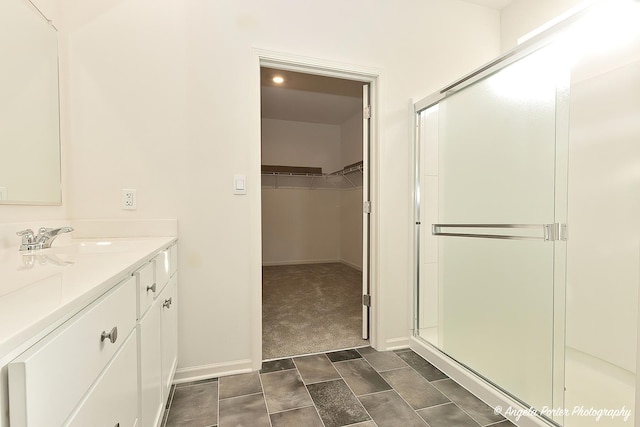 bathroom featuring vanity and a shower with shower door