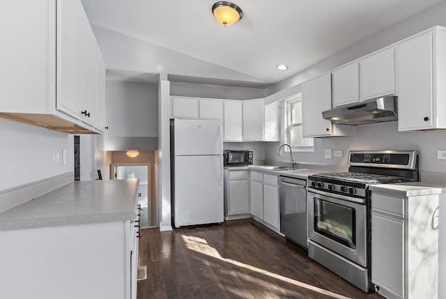 kitchen featuring vaulted ceiling, appliances with stainless steel finishes, white cabinets, and dark hardwood / wood-style flooring