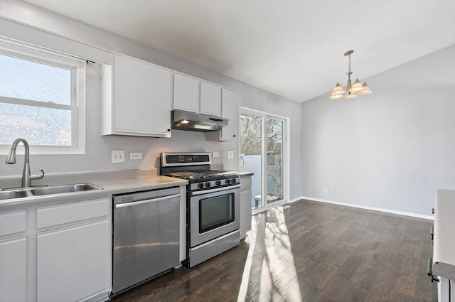 kitchen featuring sink, white cabinetry, decorative light fixtures, vaulted ceiling, and stainless steel appliances