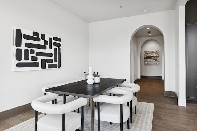 dining space with dark wood-type flooring