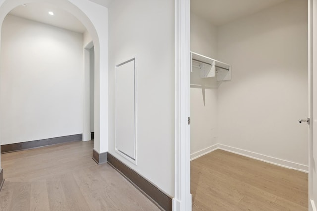 corridor with light hardwood / wood-style floors