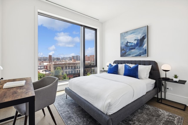 bedroom with dark hardwood / wood-style floors