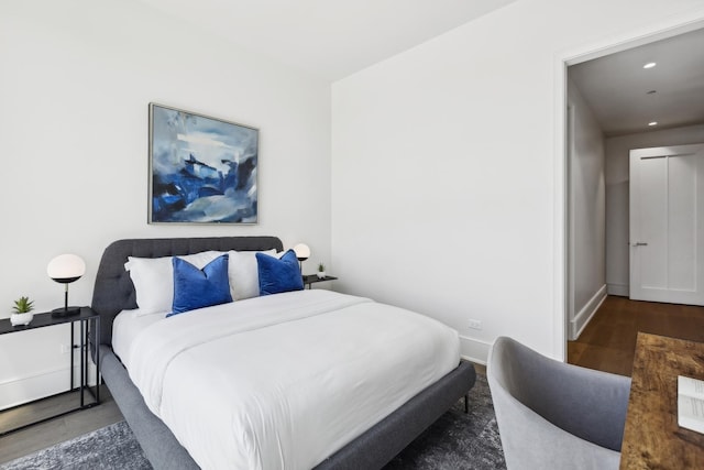 bedroom with dark wood-type flooring