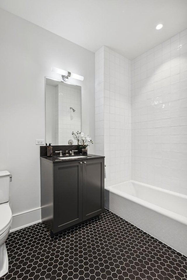 full bathroom with tile patterned flooring, vanity, toilet, and tiled shower / bath