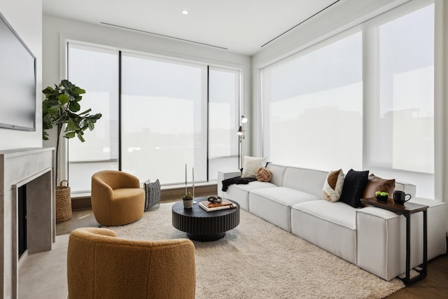 living room with a high end fireplace and a wealth of natural light