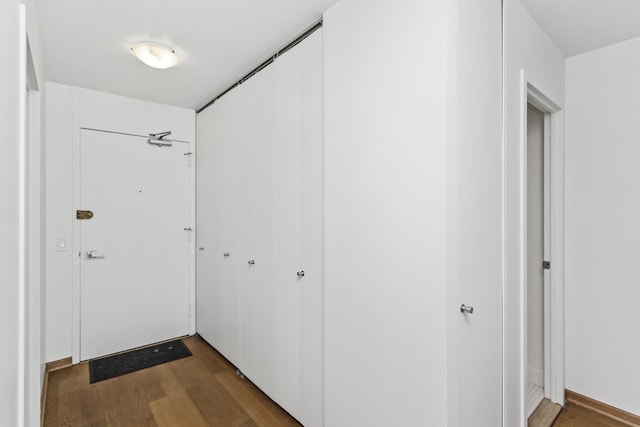 hallway with dark hardwood / wood-style floors