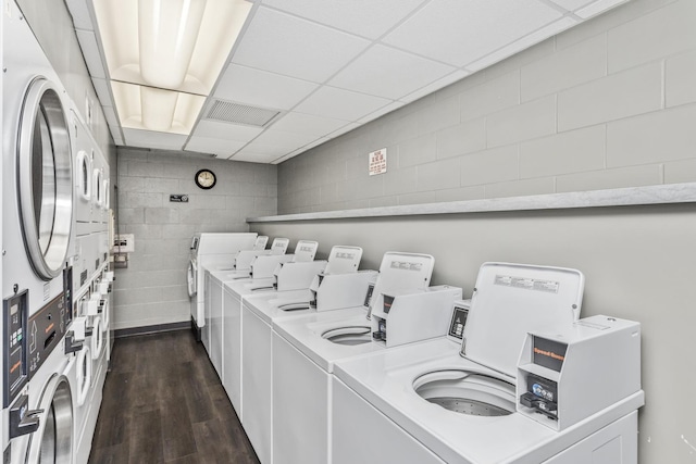 washroom featuring dark hardwood / wood-style flooring, washer and clothes dryer, and stacked washer / dryer