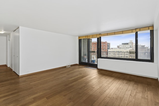 unfurnished room with wood-type flooring