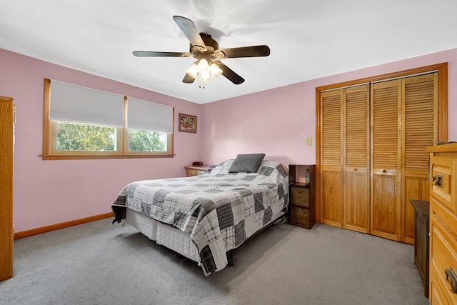 bedroom with ceiling fan, a closet, and light carpet