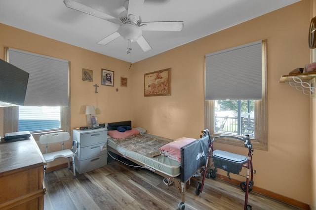 bedroom featuring ceiling fan and hardwood / wood-style flooring