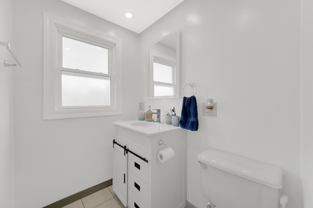 bathroom featuring toilet, tile patterned flooring, and vanity