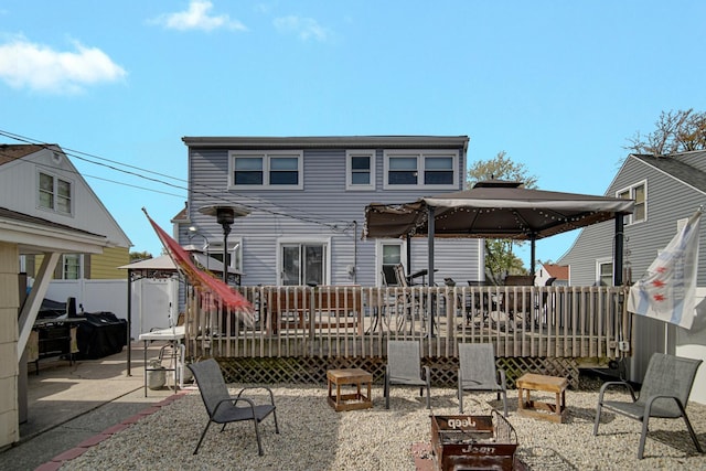 rear view of house with a patio area, a gazebo, and a deck