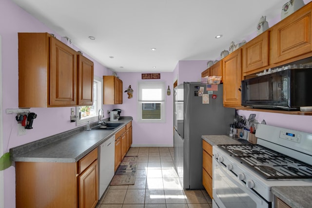 kitchen featuring sink, white appliances, and light tile patterned flooring