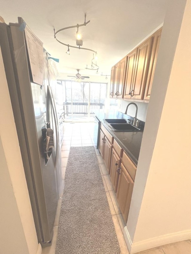 kitchen with ceiling fan, stainless steel fridge, sink, and light tile patterned flooring