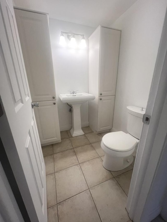 bathroom featuring toilet and tile patterned flooring