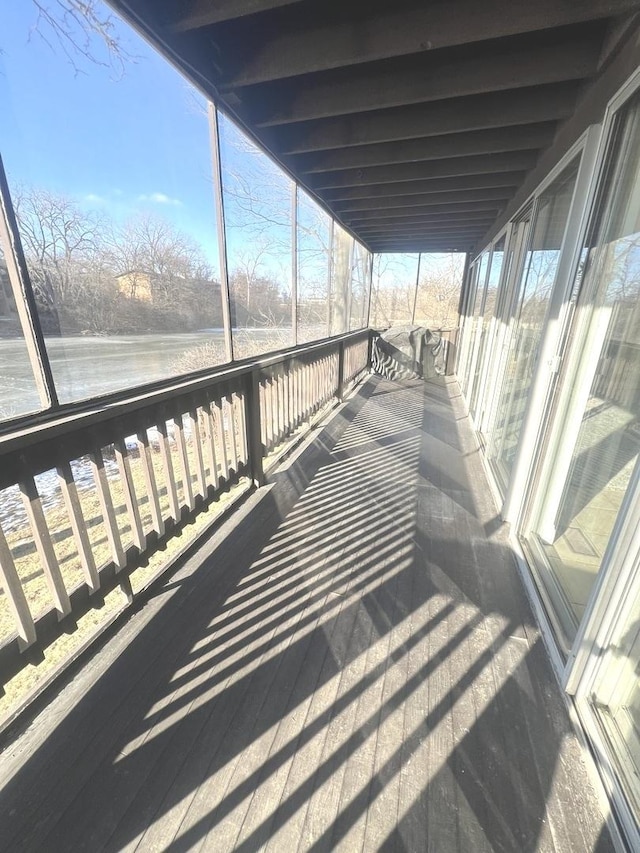 wooden deck featuring a water view