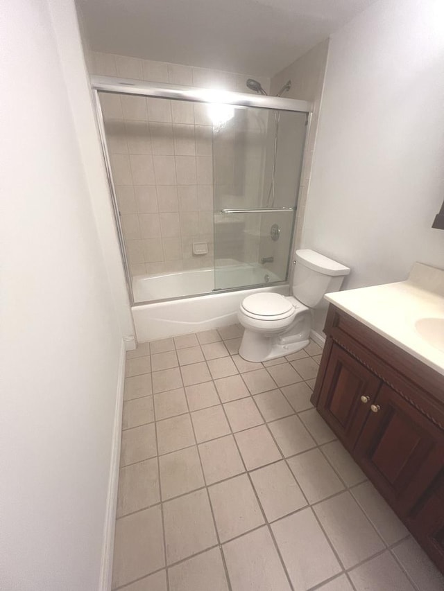 full bathroom with shower / bath combination with glass door, vanity, toilet, and tile patterned flooring