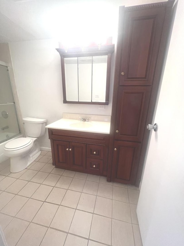 full bathroom with toilet, bath / shower combo with glass door, tile patterned flooring, and vanity